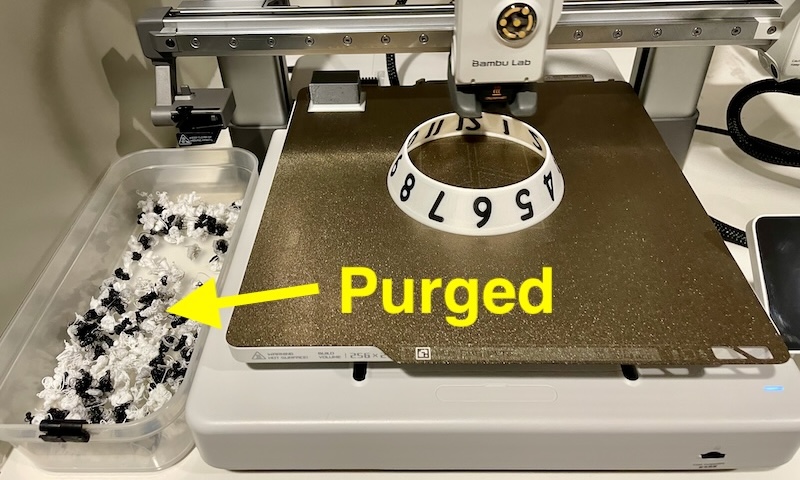 Clock being printed—lots of puged waste filament.